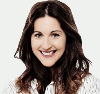 businesswoman-smiling-portrait-grey-background-800h